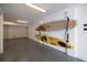 Garage features epoxy flooring and wall-mounted storage racks for kayaks and paddleboards at 19915 Gulf Blvd # 704, Indian Shores, FL 33785