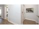 Bright hallway with hardwood floors, fresh paint, and inviting decor at 19915 Gulf Blvd # 704, Indian Shores, FL 33785