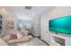 Comfortable living room with a TV, sectional sofa, and views into an adjacent office area at 19915 Gulf Blvd # 704, Indian Shores, FL 33785
