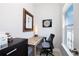 Bright office space with a window, desk, black filing cabinet, and modern artwork at 19915 Gulf Blvd # 704, Indian Shores, FL 33785