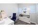 Modern home office with a white desk, ergonomic chair, and white storage unit with décor at 19915 Gulf Blvd # 704, Indian Shores, FL 33785