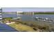 Scenic water view featuring a private dock, boats, and lush greenery extending to the horizon at 19915 Gulf Blvd # 704, Indian Shores, FL 33785