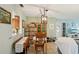 Dining area featuring a stylish light fixture, wooden table, and tile flooring at 2122 Hailstone Cir, Sun City Center, FL 33573