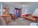 A bright living room with a ceiling fan, a futon, soft blue walls, and a screened patio view at 2268 Citrus Ct, Clearwater, FL 33763