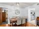 Cozy dining room featuring an elegant chandelier, a wooden table with six chairs, and hardwood flooring at 2412 Towery Trl, Lutz, FL 33549