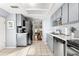 A kitchen featuring tile flooring, stainless steel appliances, and light blue walls at 2412 Towery Trl, Lutz, FL 33549