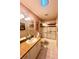 Bathroom featuring a mirrored vanity, white cabinets, toilet and a tub with sliding glass doors at 2439 Hidden Trail Dr, Spring Hill, FL 34606
