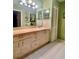 Bathroom features a vanity with a countertop and sink and a large mirror at 2439 Hidden Trail Dr, Spring Hill, FL 34606