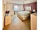Bedroom with natural light from a window, ceiling fan, and neutral and purple walls at 2439 Hidden Trail Dr, Spring Hill, FL 34606