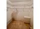 Walk-in closet includes a storage cabinet, metal racks, and linoleum flooring at 2439 Hidden Trail Dr, Spring Hill, FL 34606