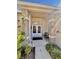 Charming front entrance with a brick column porch and lush landscaping, offering a warm welcome at 2439 Hidden Trail Dr, Spring Hill, FL 34606