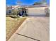 Charming home with a manicured lawn, inviting entrance, and two-car garage on a sunny day at 2439 Hidden Trail Dr, Spring Hill, FL 34606