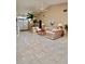 Spacious living room featuring high ceilings, tile flooring, and a cozy seating area at 2439 Hidden Trail Dr, Spring Hill, FL 34606