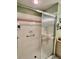 Bathroom with a tiled shower and glass doors, a soap dish, and green and white wall tiles at 2439 Hidden Trail Dr, Spring Hill, FL 34606
