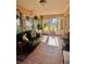 Inviting sun room featuring patterned tile flooring and tranquil views of the outdoor landscape at 2439 Hidden Trail Dr, Spring Hill, FL 34606