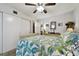 Bright bedroom features a ceiling fan, closet, and dresser with mirror at 2459 Columbia Dr # 3, Clearwater, FL 33763