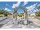 Unique courtyard with a colonnade structure featuring detailed columns and arches, set against a blue sky with fluffy clouds at 2459 Columbia Dr # 3, Clearwater, FL 33763