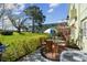 Outdoor patio with a table, seating, grill, lush foliage and manicured green lawn at 2459 Columbia Dr # 3, Clearwater, FL 33763