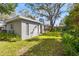 Large backyard with a custom grilling station and a large tree at 2728 Forest N Pkwy, Largo, FL 33771