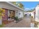 Front entry courtyard featuring brick pavers, exterior door and landscaped garden at 2728 Forest N Pkwy, Largo, FL 33771