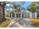 Beautiful single-story home with fenced courtyard entrance, mature landscaping and a long driveway at 2728 Forest N Pkwy, Largo, FL 33771