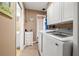 Functional laundry room with modern washer and dryer units, storage cabinets, and neutral tones at 2728 Forest N Pkwy, Largo, FL 33771