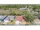 Aerial view of a home with a well-kept yard and landscaping, set in a neighborhood with mature trees at 29443 Zeller Ave, San Antonio, FL 33576