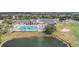Expansive aerial view of community pool, clubhouse, golf course, and pond within the Tampa Bay Golf & Country Club at 29443 Zeller Ave, San Antonio, FL 33576