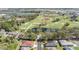 Scenic aerial view of golf course community with lush greenery, ponds, and a convenient highway nearby at 29443 Zeller Ave, San Antonio, FL 33576