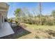 An inviting home backyard with a well-maintained lawn, lush trees, and a wooden patio deck at 29443 Zeller Ave, San Antonio, FL 33576