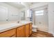 Bathroom with a large vanity, built in shelves, shower with tub and wood look floors at 29443 Zeller Ave, San Antonio, FL 33576