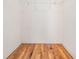 Walk-in closet with wood flooring and metal storage rack at 29443 Zeller Ave, San Antonio, FL 33576