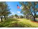 A charming community clubhouse framed by mature trees and vibrant landscaping at 29443 Zeller Ave, San Antonio, FL 33576