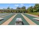 Outdoor cornhole courts with shaded seating area, offering residents a great outdoor activity at 29443 Zeller Ave, San Antonio, FL 33576