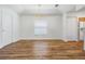 Dining area features hardwood floors, neutral paint, and elegant light fixture at 29443 Zeller Ave, San Antonio, FL 33576