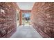 The covered entryway features stylish brick walls leading to the front door at 29443 Zeller Ave, San Antonio, FL 33576