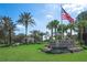 View of the Tampa Bay Golf & Country Club entrance with lush landscaping and a clear blue sky at 29443 Zeller Ave, San Antonio, FL 33576