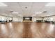 Spacious event space featuring hardwood flooring, stage, and ample seating, perfect for hosting memorable occasions at 29443 Zeller Ave, San Antonio, FL 33576