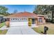 Red brick exterior with two-car garage and large driveway at 29443 Zeller Ave, San Antonio, FL 33576