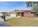 Charming single-story brick home featuring a well-manicured lawn and attached two-car garage at 29443 Zeller Ave, San Antonio, FL 33576