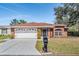Charming single-story brick home featuring a well-manicured lawn and attached two-car garage at 29443 Zeller Ave, San Antonio, FL 33576