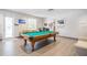 The game room has a beautiful pool table, cozy seating, and plenty of natural light, perfect for entertaining at 29443 Zeller Ave, San Antonio, FL 33576
