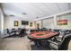 Relax and enjoy the game in this game room with poker tables, plush chairs, and a wall-mounted television at 29443 Zeller Ave, San Antonio, FL 33576