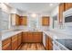 Traditional kitchen with wood cabinets, sleek countertops, and bright lighting at 29443 Zeller Ave, San Antonio, FL 33576