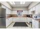 Bright kitchen with white cabinets, stainless steel fridge, ample counter space, and natural light from the window at 29443 Zeller Ave, San Antonio, FL 33576