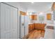Bright kitchen with wood cabinets, white appliances, and wood-look flooring at 29443 Zeller Ave, San Antonio, FL 33576