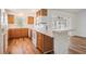 Traditional kitchen with wood cabinets, sleek countertops, and a convenient breakfast bar at 29443 Zeller Ave, San Antonio, FL 33576