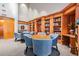 Inviting library with wood bookshelves, tables, and comfortable blue upholstered chairs at 29443 Zeller Ave, San Antonio, FL 33576