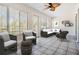 Cozy living room featuring tile floors, neutral tones, ceiling fan, and light filled windows at 29443 Zeller Ave, San Antonio, FL 33576