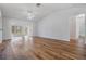 Bright and airy living room with wood flooring and open floor plan to sun room at 29443 Zeller Ave, San Antonio, FL 33576